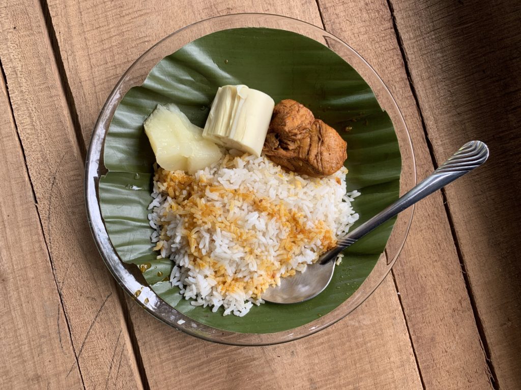 chicken rice and yuca served on banana leaf